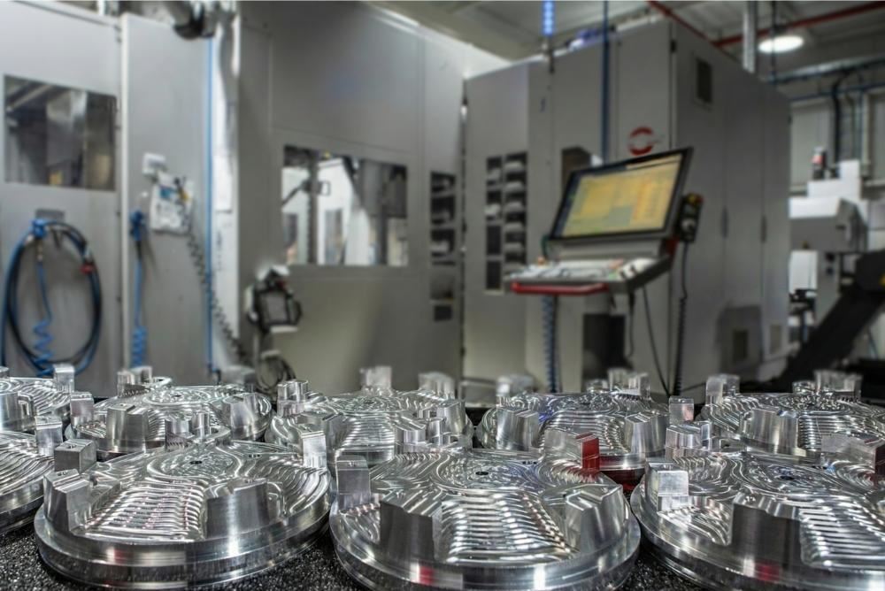 Machined discs staged in front of automated machining centres