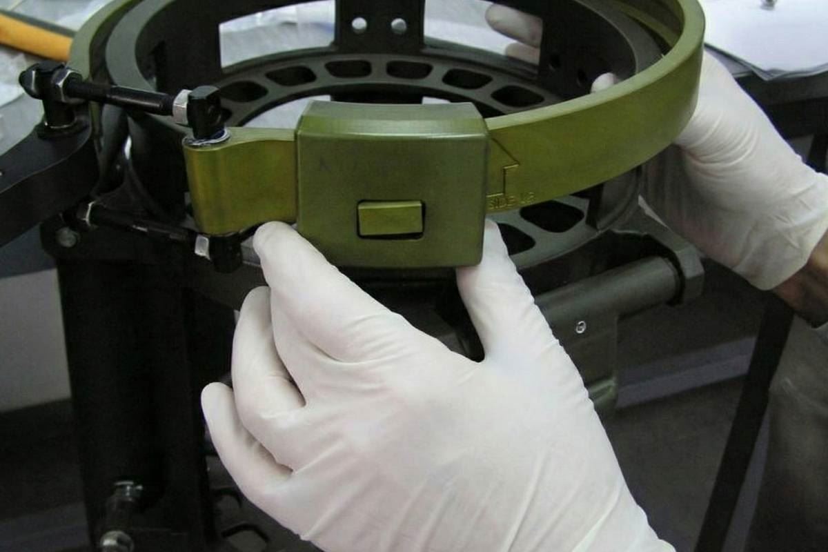 Gloved technician fitting a clamped ring subassembly
